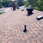 Ace Roofing Services Inc - Asphalt Shingle Roofing - Toronto Roofing Company - Picture of a shingle roof with chimney, maximum vent and vent in Toronto. GTA