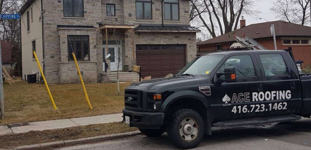 Roofing truck parked near house