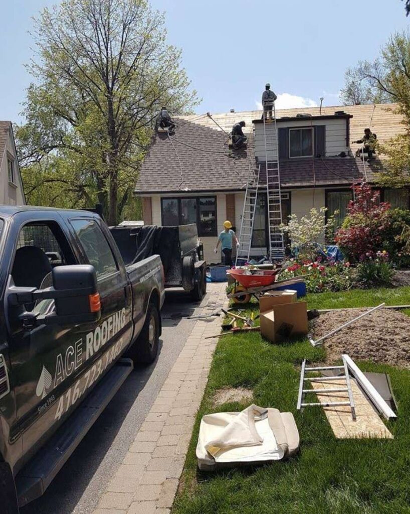 Roofing crew working on house