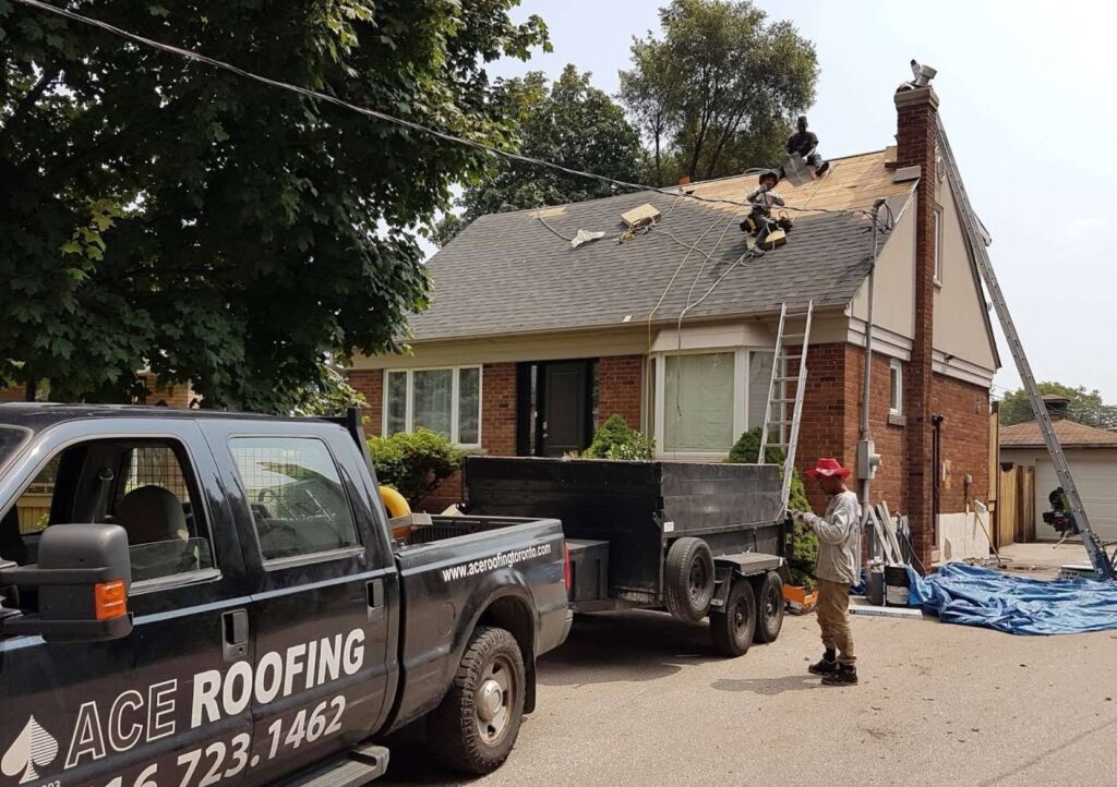 Roofing work in progress, truck nearby.