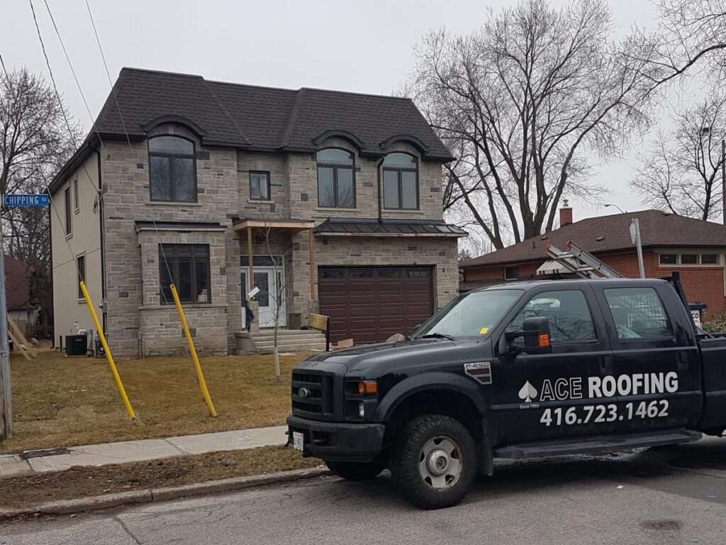 Roofing truck parked near house