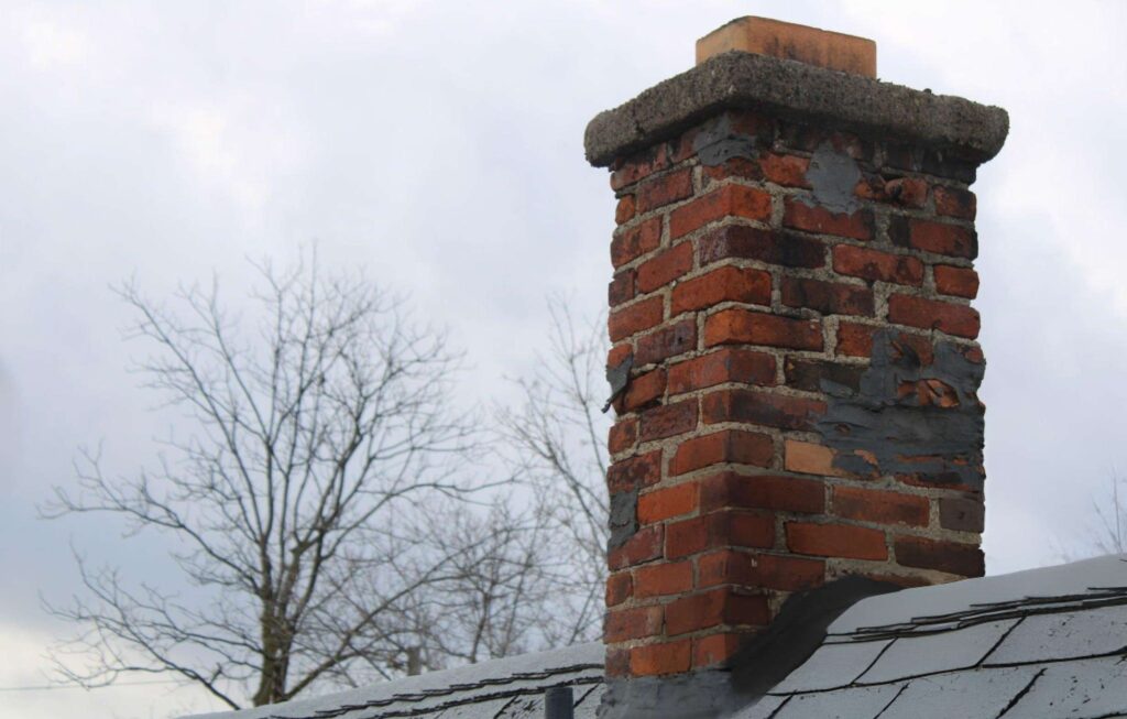 Chimney removal service toronto (2) Old brick chimney on a roof