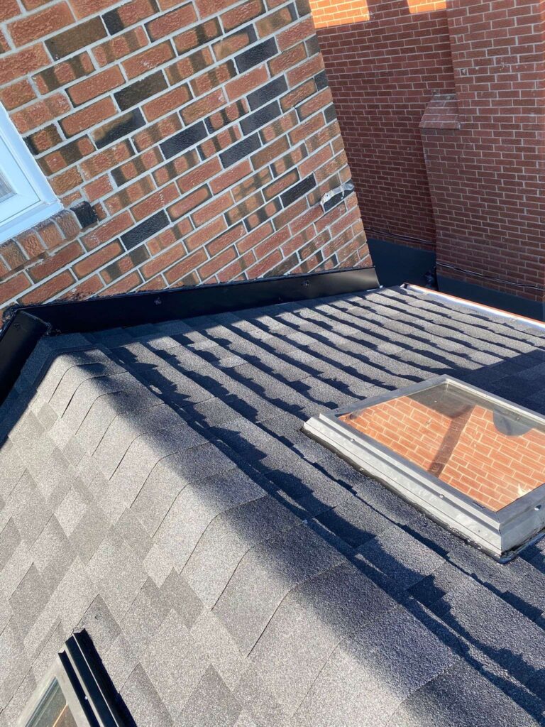 Shingle-Roofing-Service-Toronto (5) Roof with skylight and brick wall
