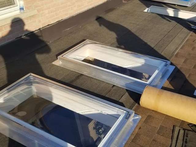 Skylights being installed on roof