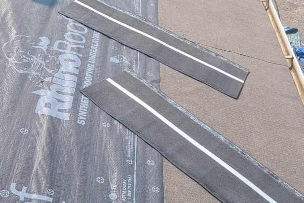 asphalt-shingle-roof-installation-with-underlayment-and-shingle-strips