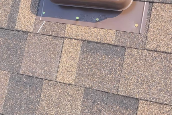 brown-roof-vent-installed-on-asphalt-shingles